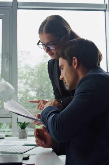 Salarié et responsable examinent un planning de travail imprimé lors d’un échange au bureau.